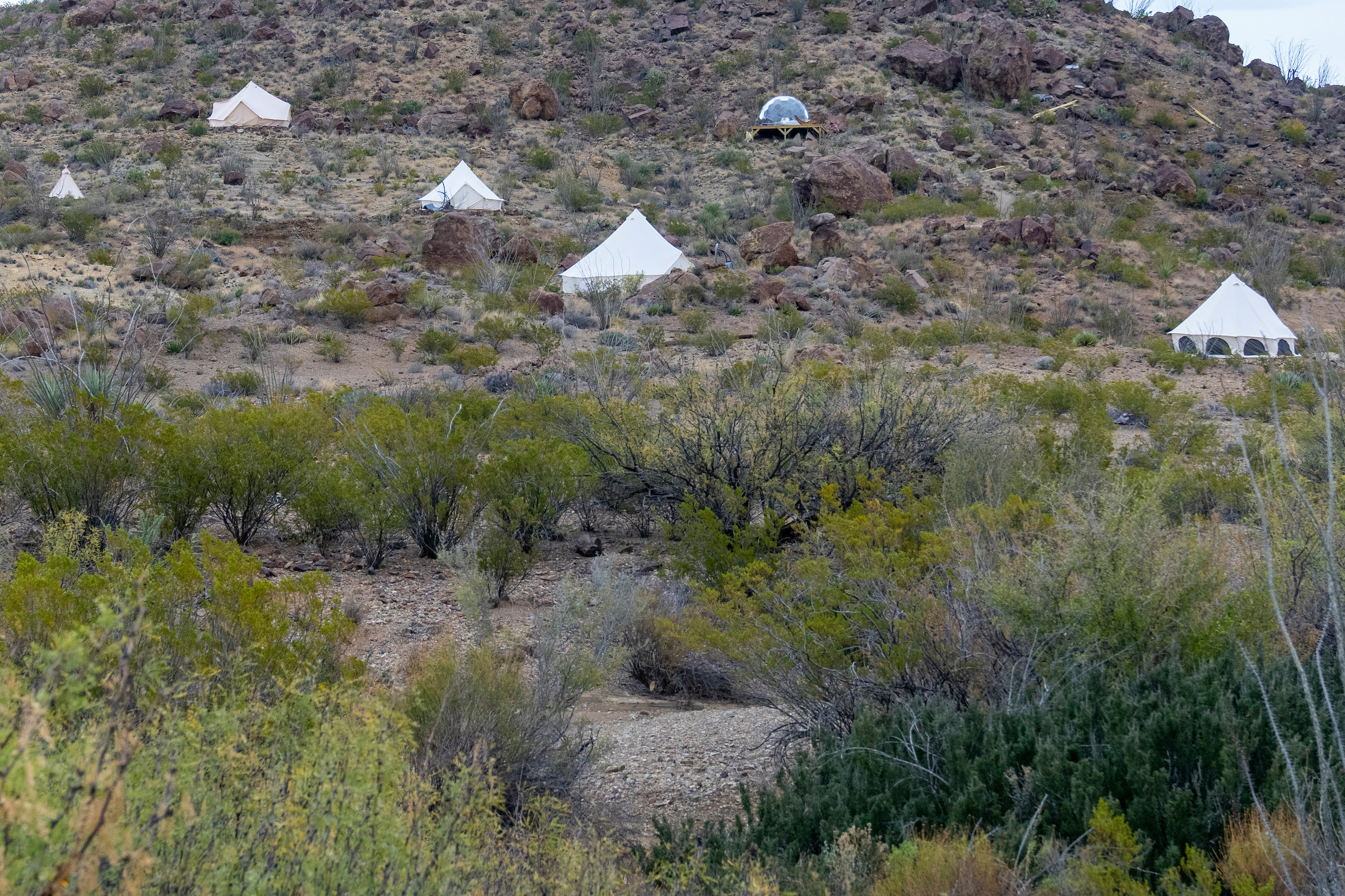 Tents set up on a mountainside.