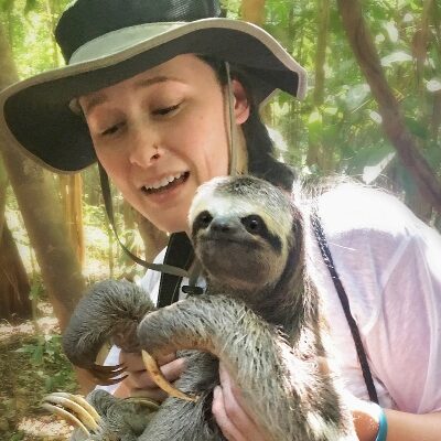 A student holding a sloth in Fiji.