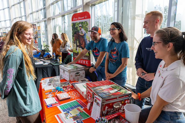 Students surrounding a table and talking at the memorial student center.