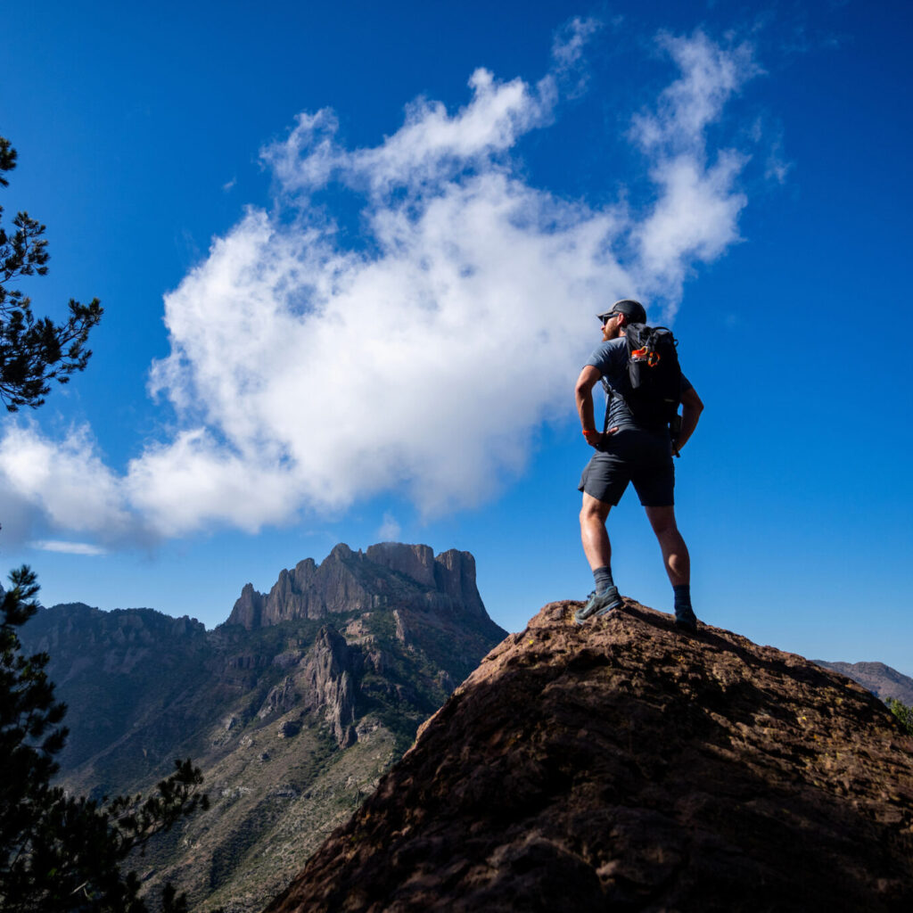 person standing on top of a mountain